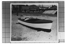small Starboard bow view of unknown boat on beach.